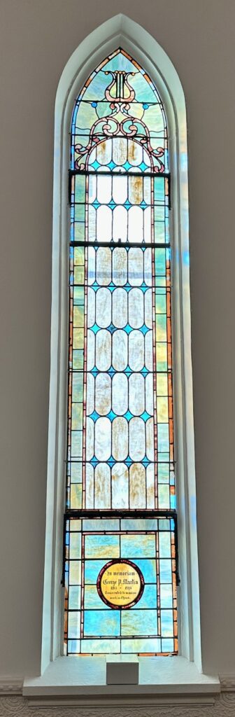 A stained glass window in the center of a room.