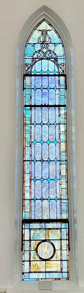 A stained glass window with blue and green designs.