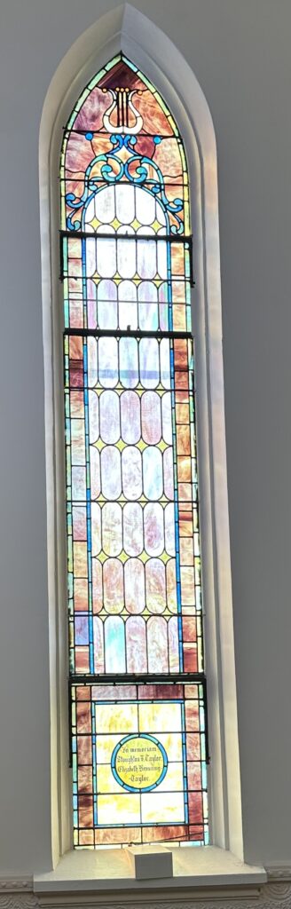 A stained glass window in the center of a room.