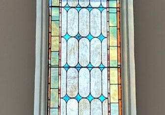 A stained glass window in the center of a room.