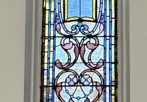 A stained glass window in the center of a room.