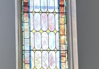 A stained glass window in the center of a room.